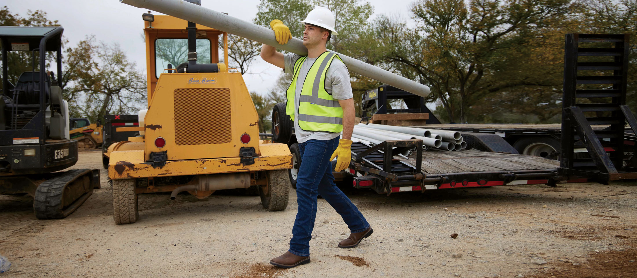 A construction worker wearing Justin Work boots on a job site